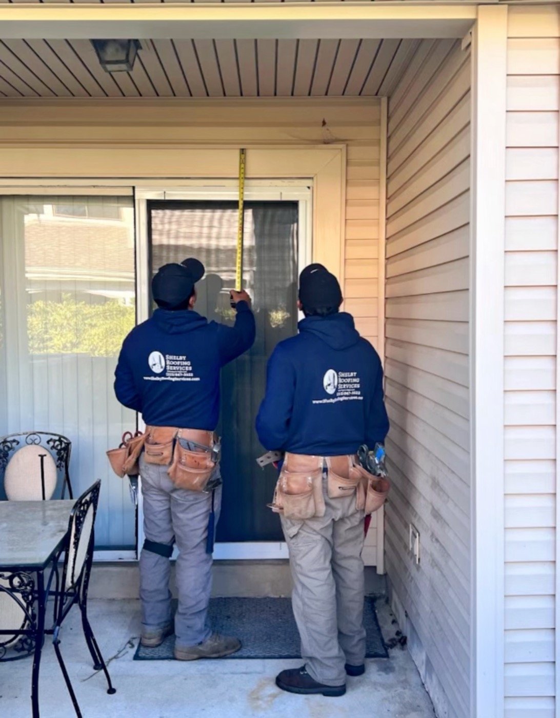 Shelby Roofing Services project manager measuring for exterior window and door installation PA