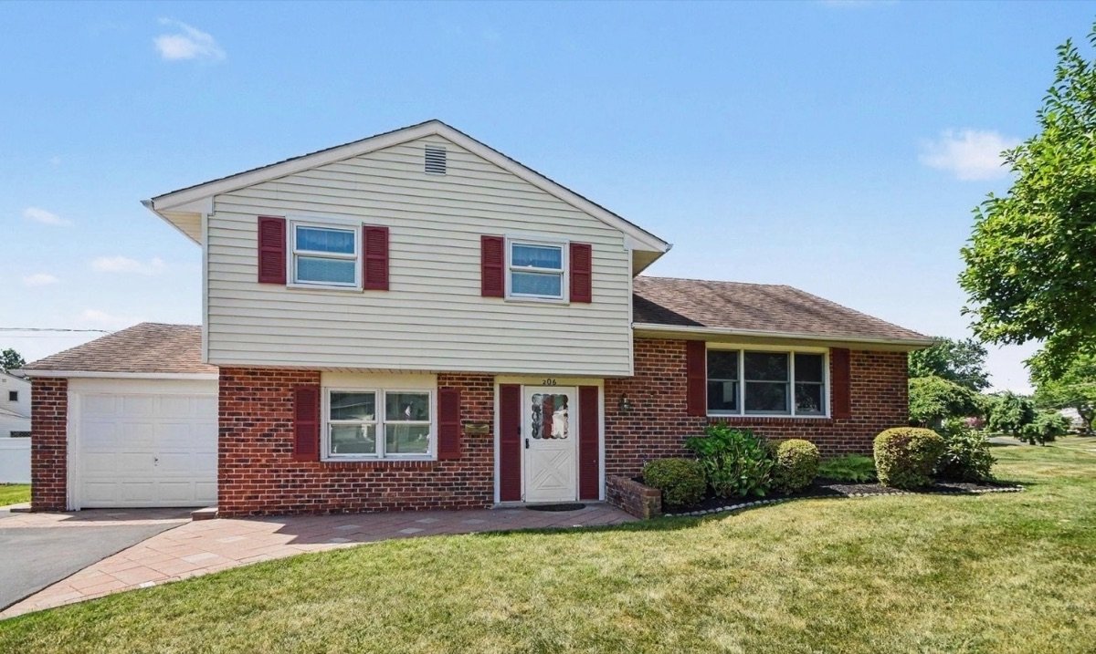 Before fiber cement siding installation — yellow house with red shutters, Blue Bell PA area