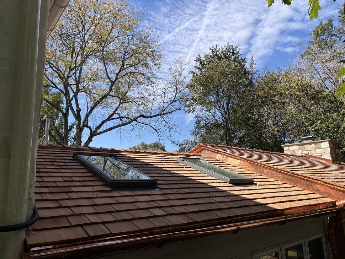 Replaced skylights on a cedar shake sunroom roof with copper flashing and half-round copper gutters, Bryn Athyn, PA, by Shelby Roofing Services