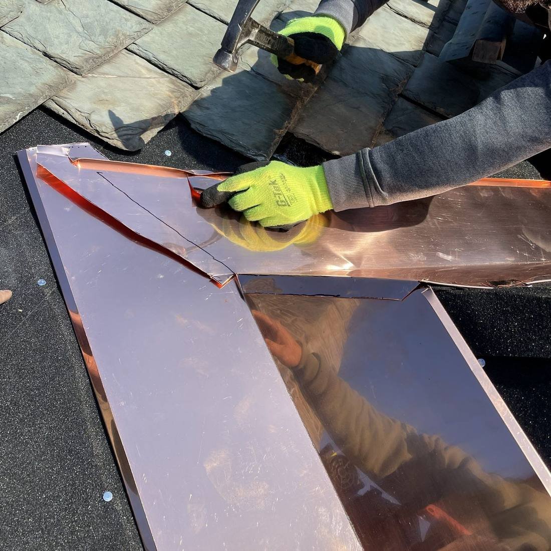 Custom copper valley being installed on a natural slate roof by Shelby Roofing Services