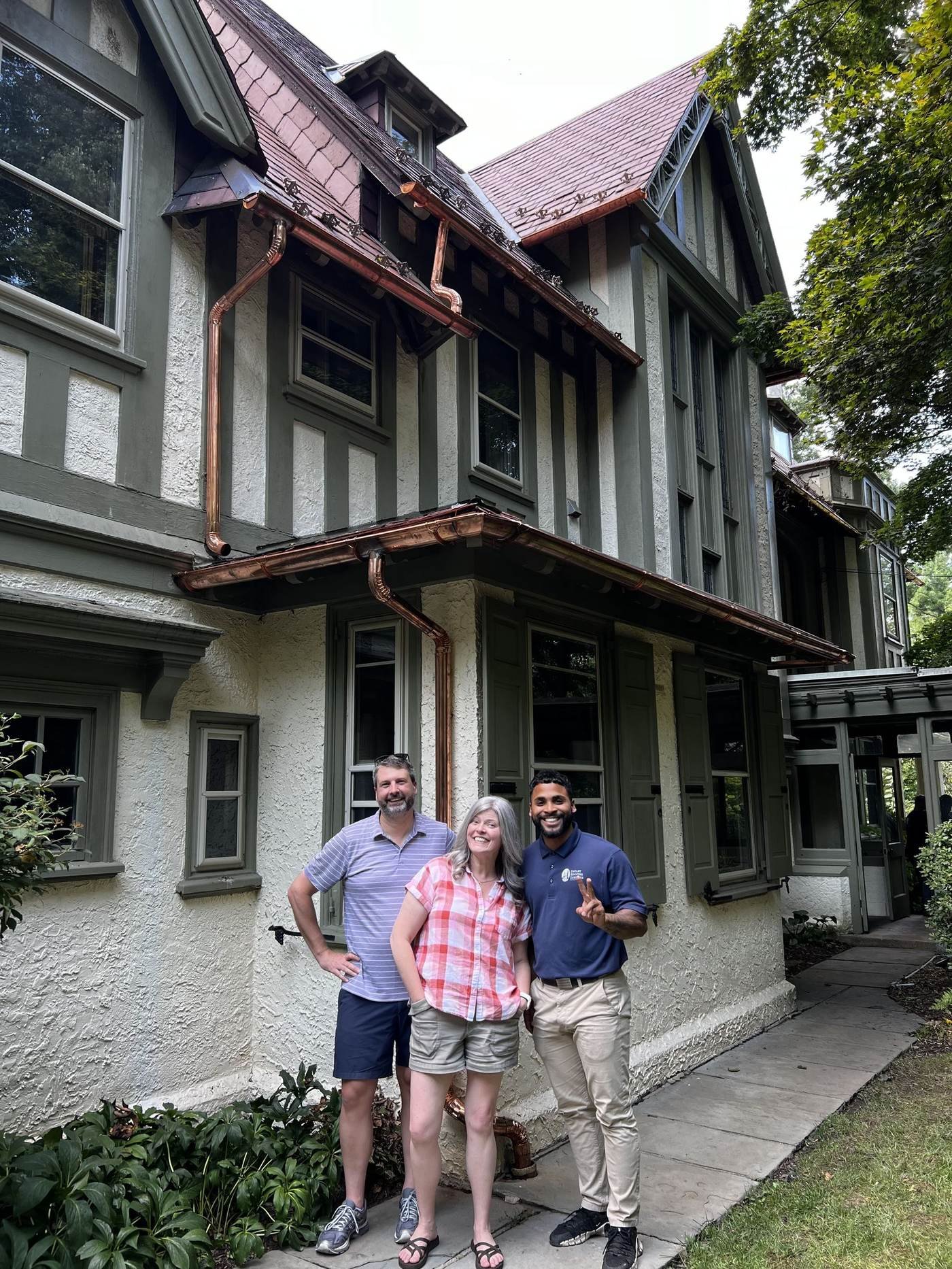 Miguel Cespedes with satisfied homeowners after completing a copper gutter installation — Greater Philadelphia Area