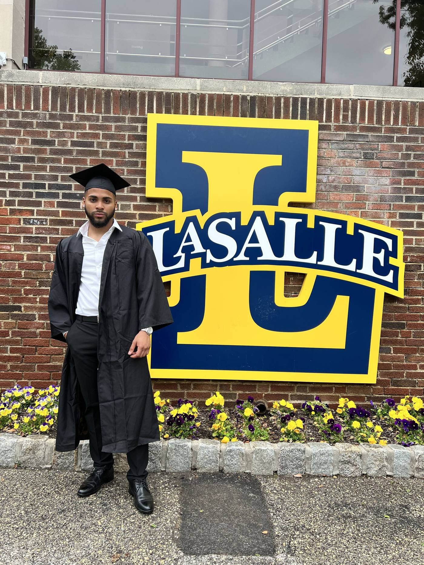 Miguel Cespedes in front of La Salle University sign at graduation