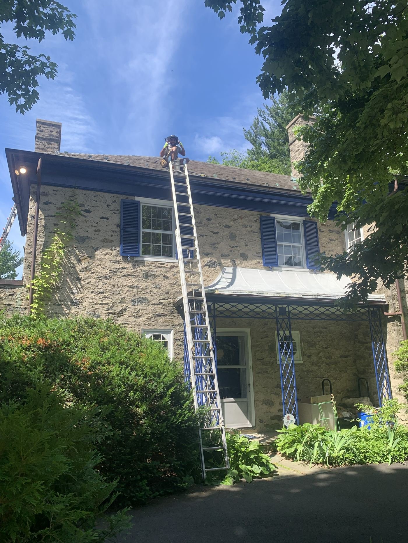 Miguel Cespedes performing a slate roof repair on a historic stone colonial home — specialized roofing, PA