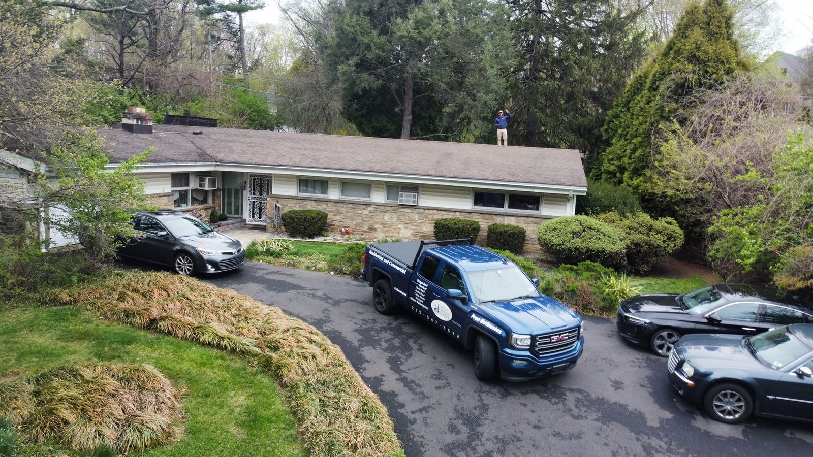 Shelby Roofing Services truck in the driveway with Miguel on the roof — homeowner consultation and inspection, Greater Philadelphia Area