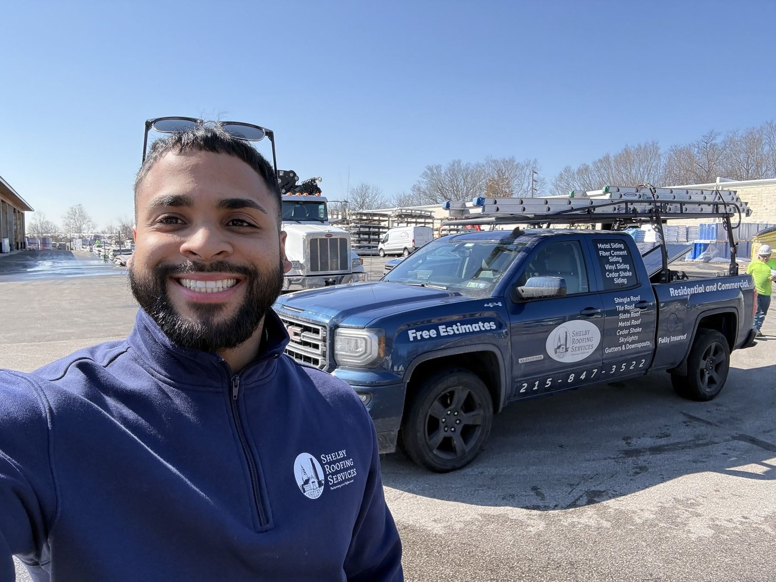 Miguel Cespedes with Shelby Roofing Services branded truck at materials yard
