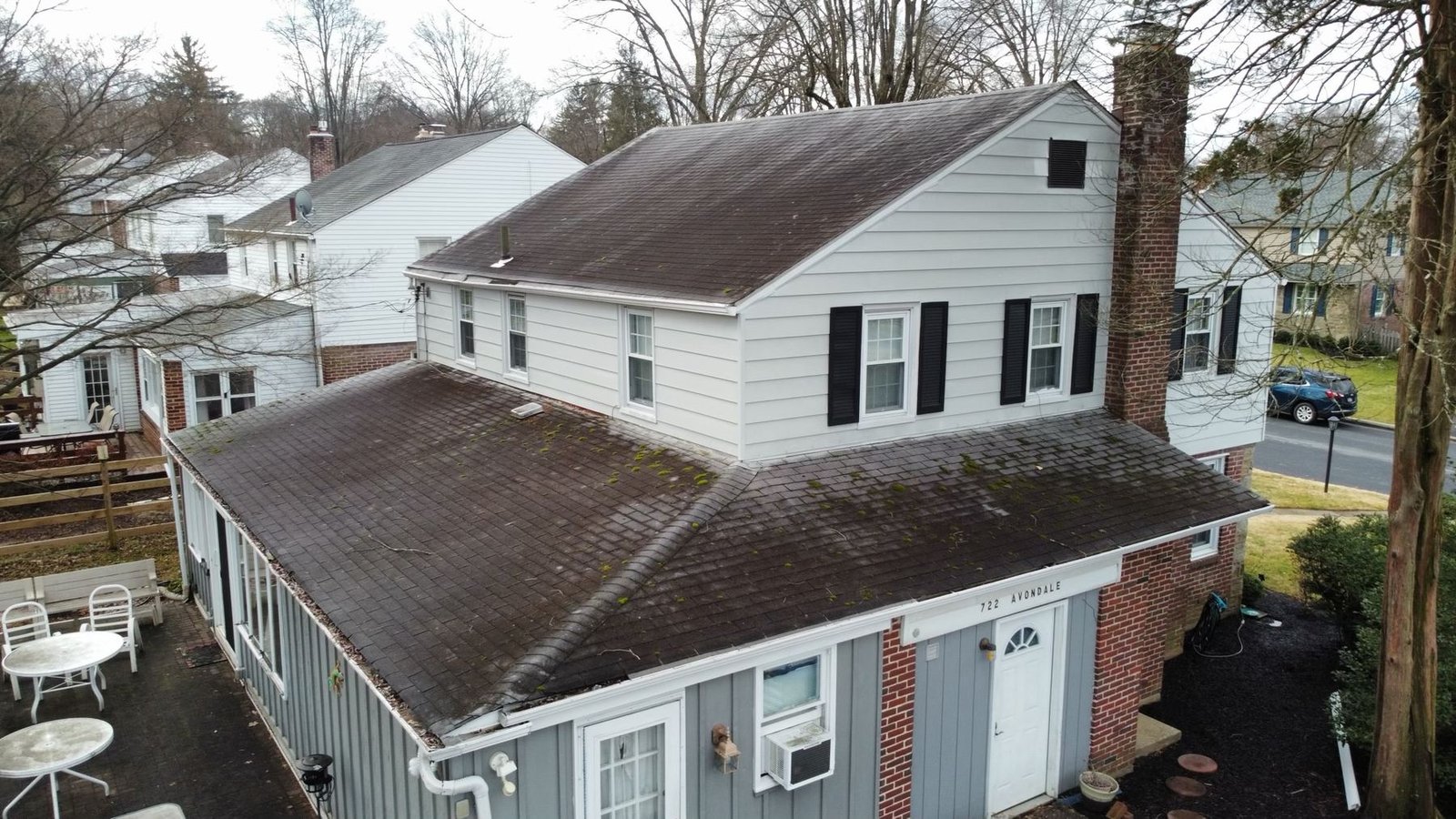 Before — rear and side aerial view of worn dark shingle roof, PA
