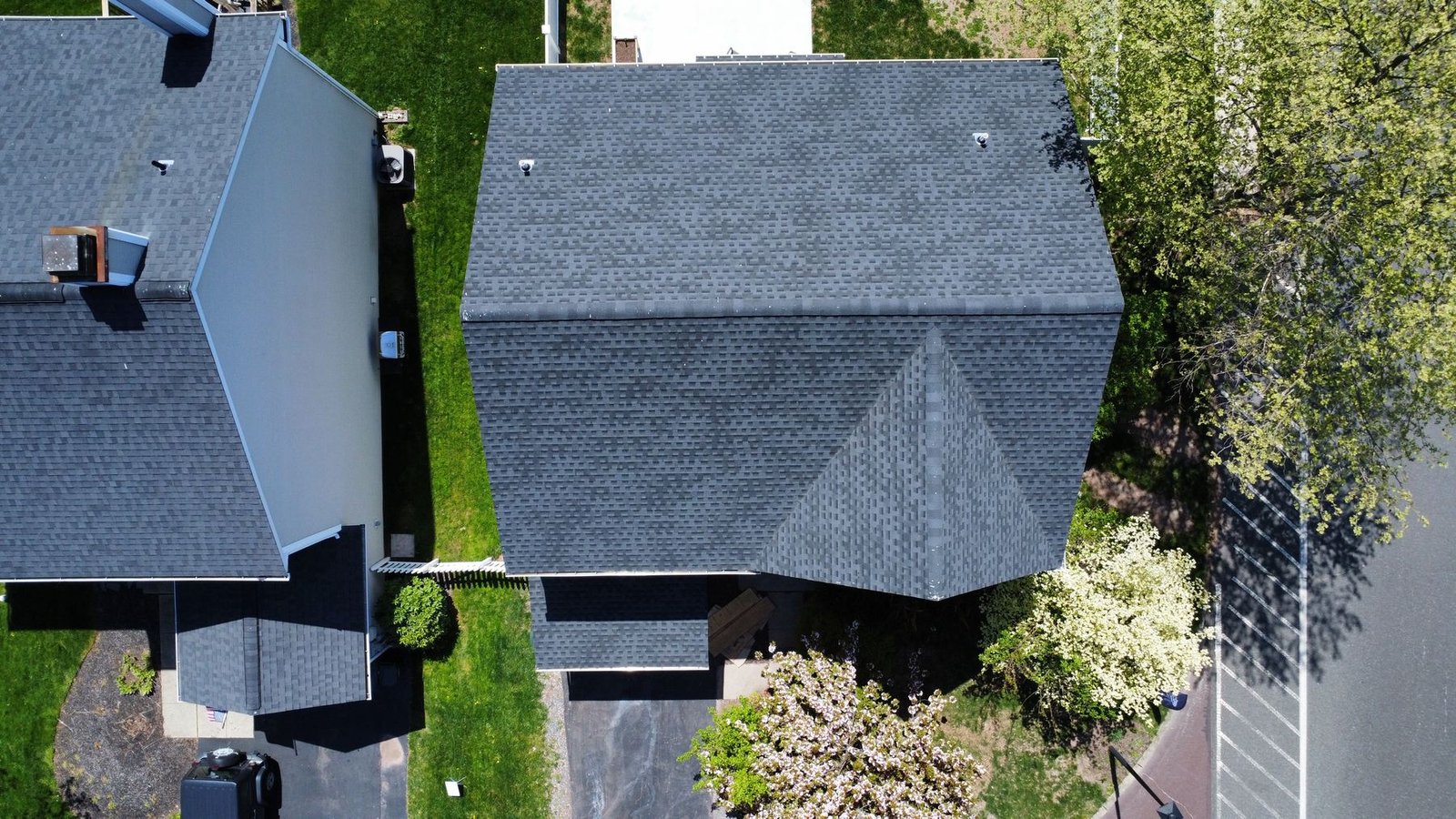 After — top-down aerial of completed charcoal shingle roof on renovated home — Shelby Roofing Services PA