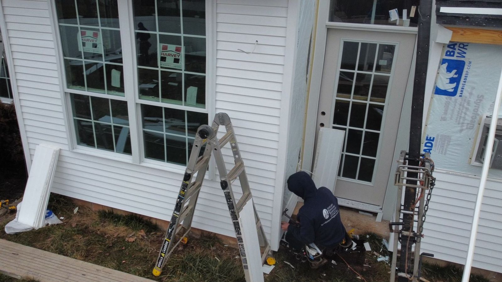 In-progress — crew installing new Harvey windows during exterior renovation, PA