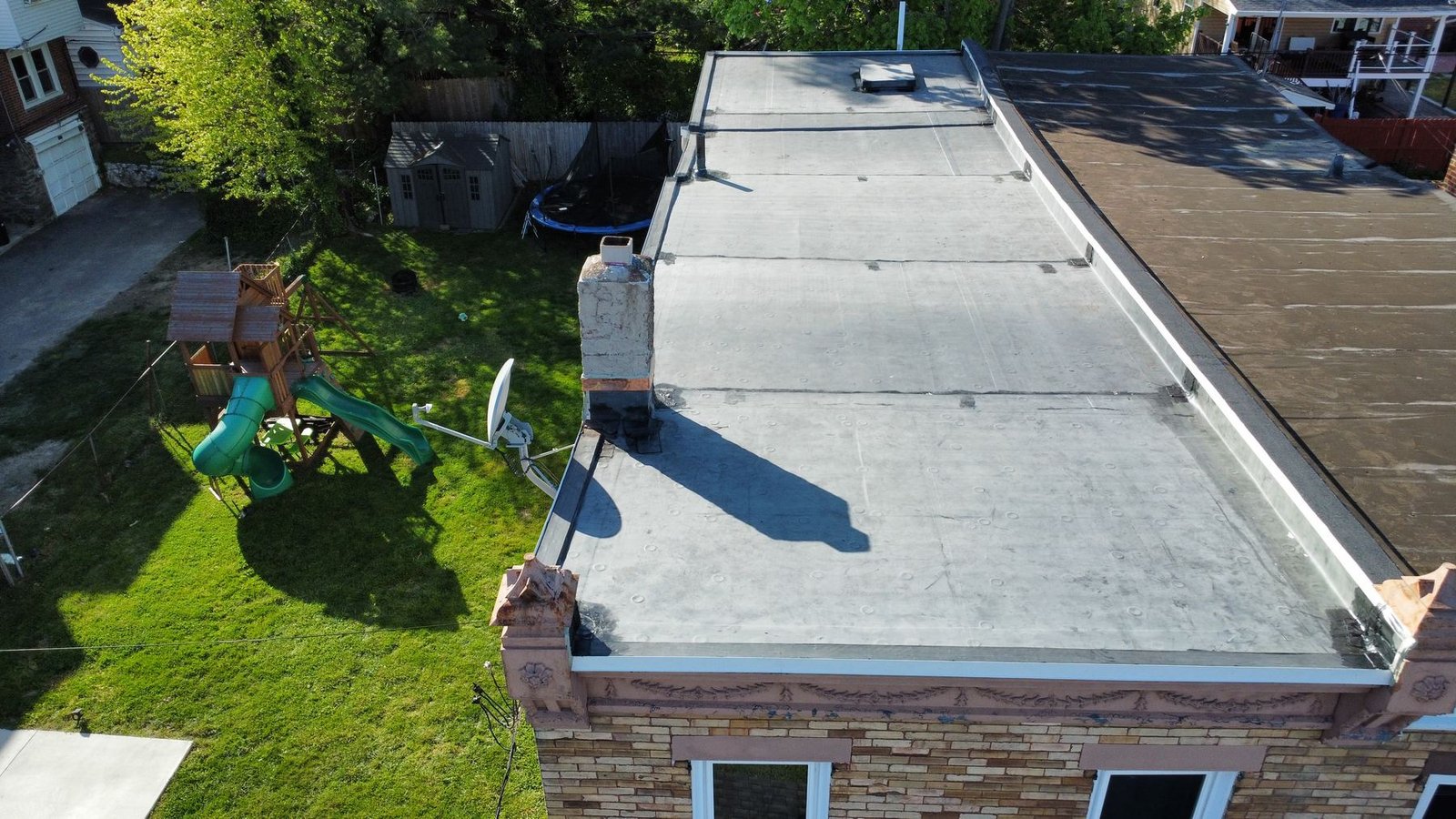 After — rear aerial showing new EPDM flat roof installed on urban row home — Shelby Roofing Services PA