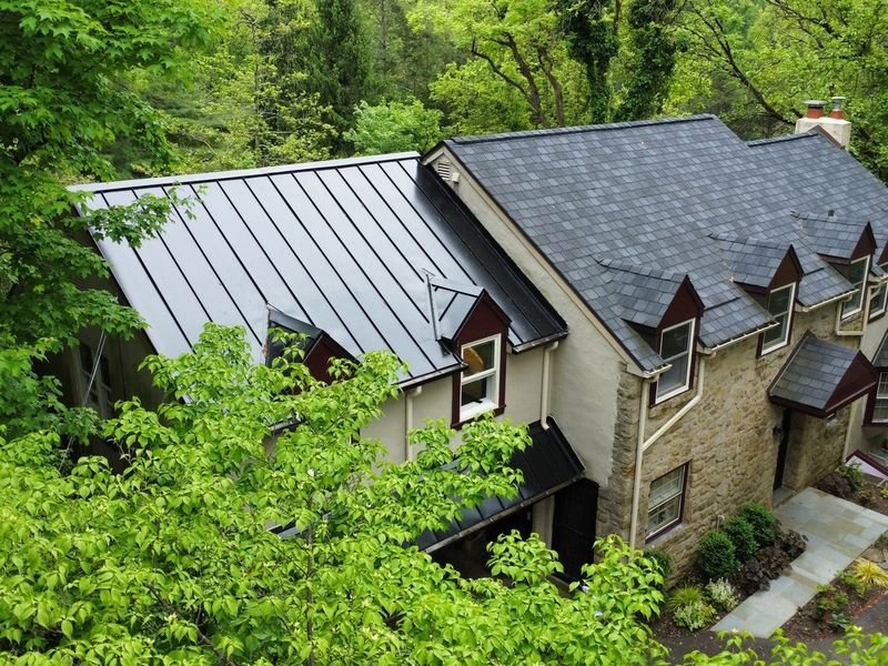 Standing seam metal roof installed on a stone home in Chestnut Hill — Shelby Roofing Services