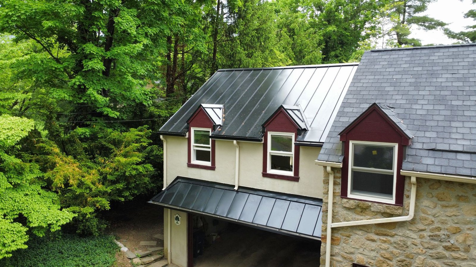 After — close-up of completed charcoal standing seam metal roof with red dormers — Shelby Roofing Services PA