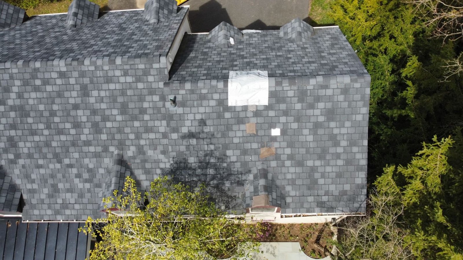 Before — wide aerial showing algae-stained damaged shingles across full roof, PA