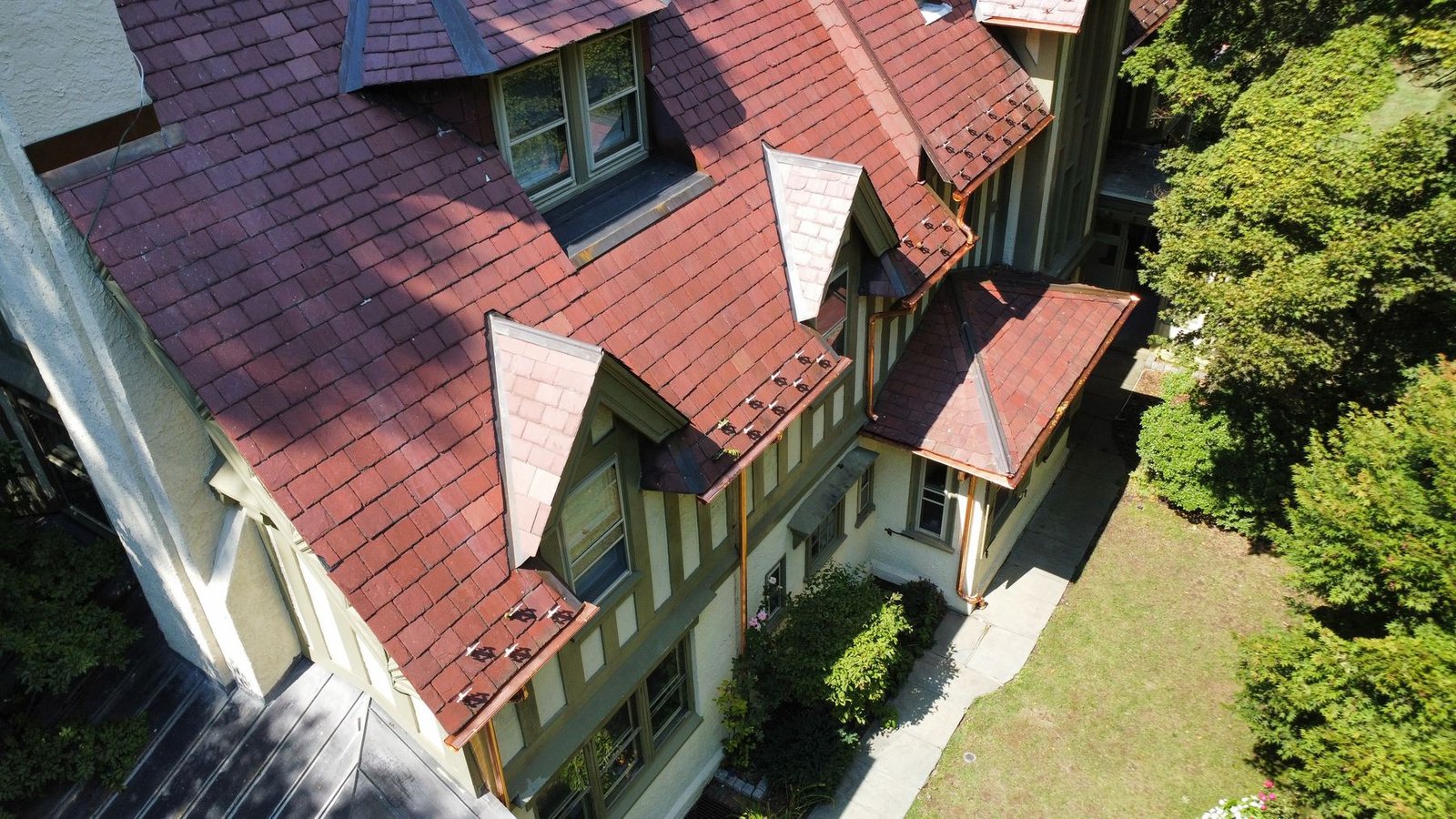 Completed — aerial view of Tudor estate showing new copper gutters and downspouts throughout — Shelby Roofing Services PA