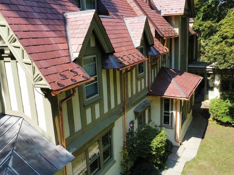 Tudor home in Chestnut Hill with new copper gutters and downspouts — Shelby Roofing Services