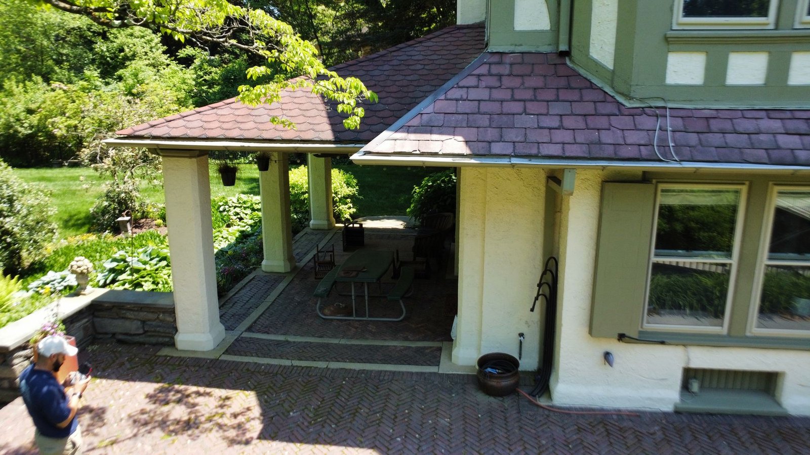 Before — aerial of covered porch area showing old gutter condition on slate tile roof, PA