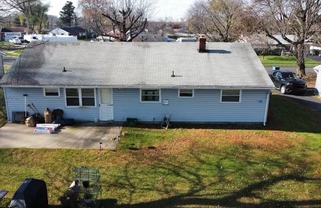 Before — front aerial of ranch home with old gray shingles, PA