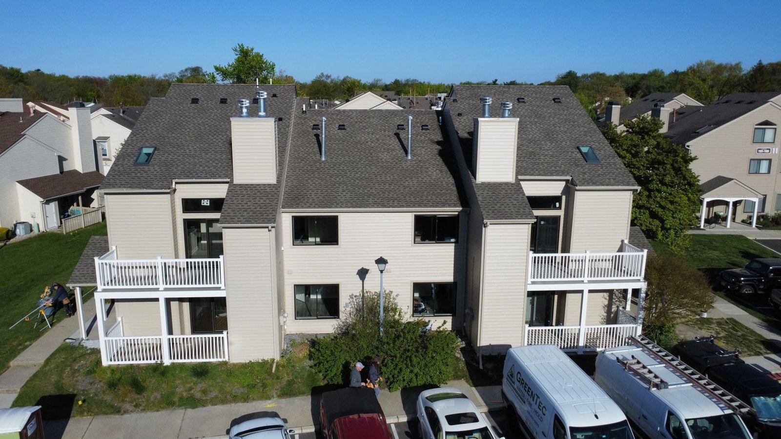 After — front aerial of condo complex with completed new shingles and siding — Shelby Roofing Services PA