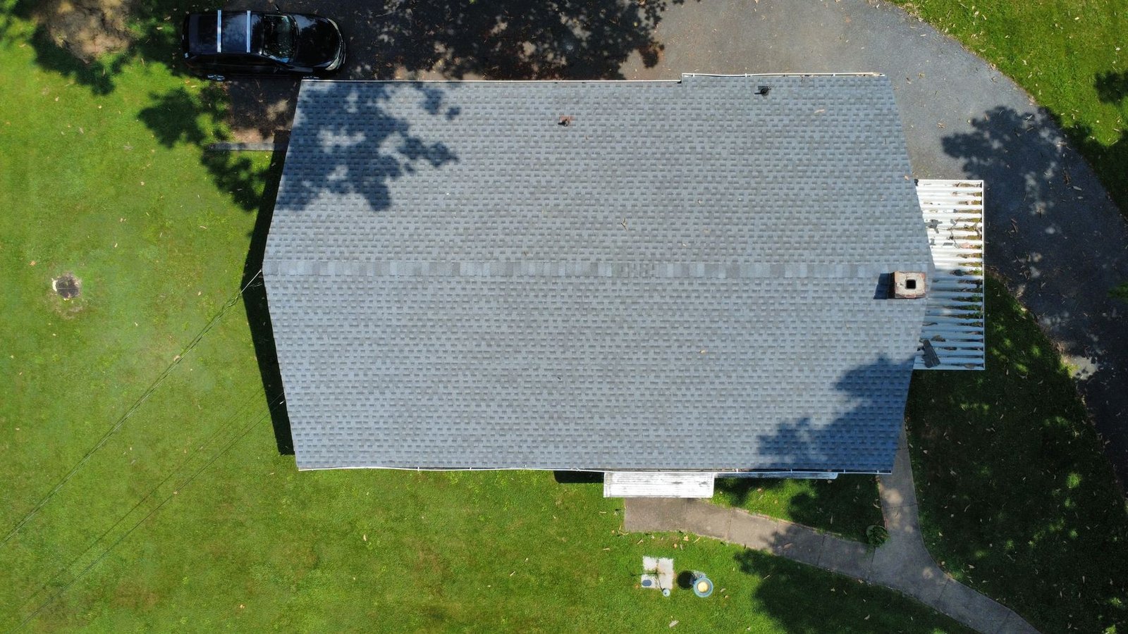 After — top-down aerial of completed brick ranch — Shelby Roofing Services PA