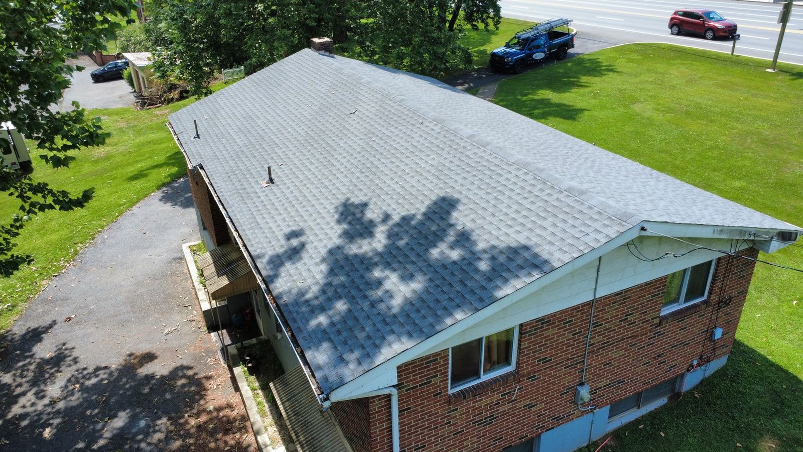After — wide aerial of completed brick ranch — Shelby Roofing Services PA
