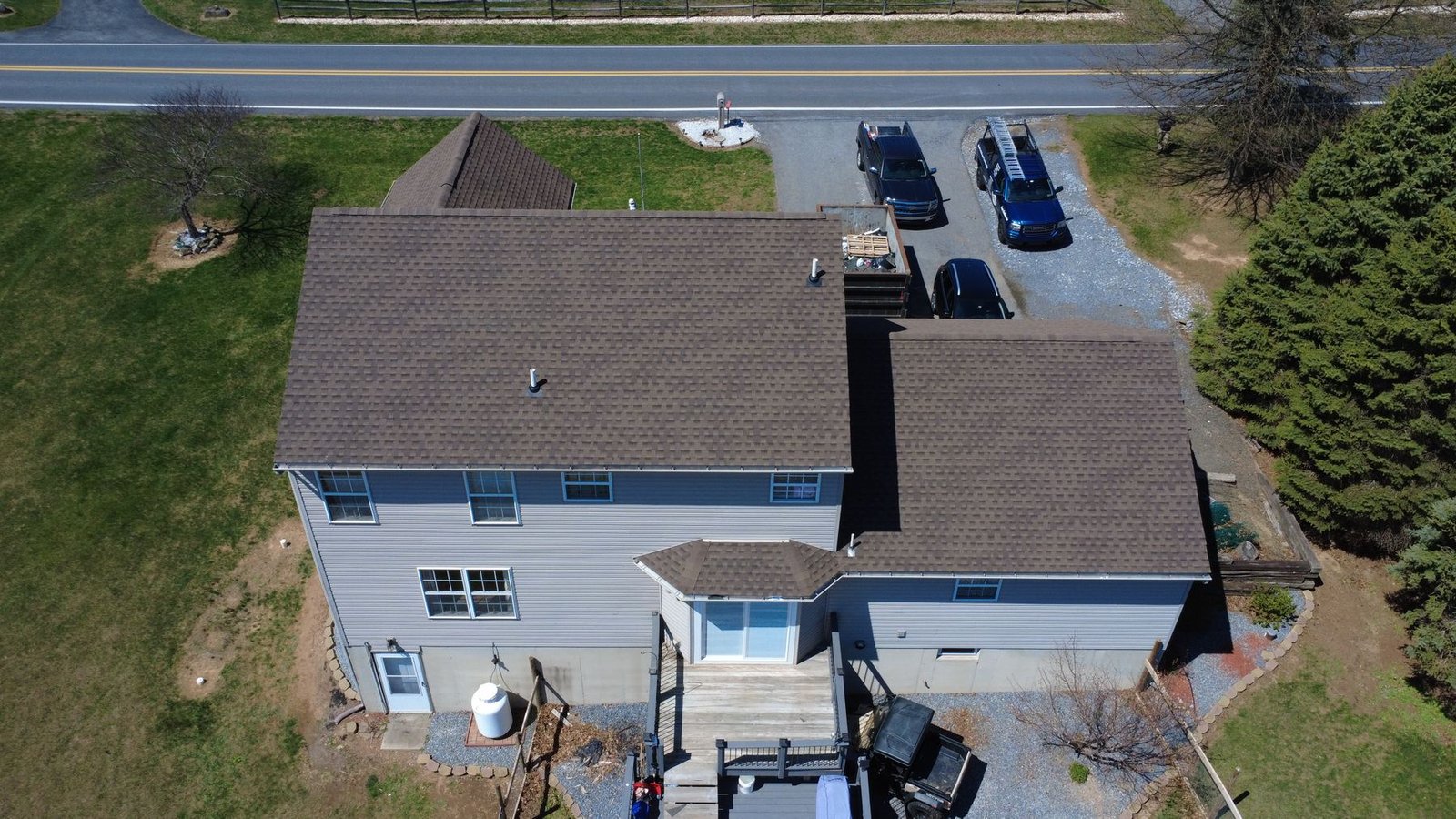 After — top-down aerial of completed 2-story colonial with new tan shingles — Shelby Roofing Services PA