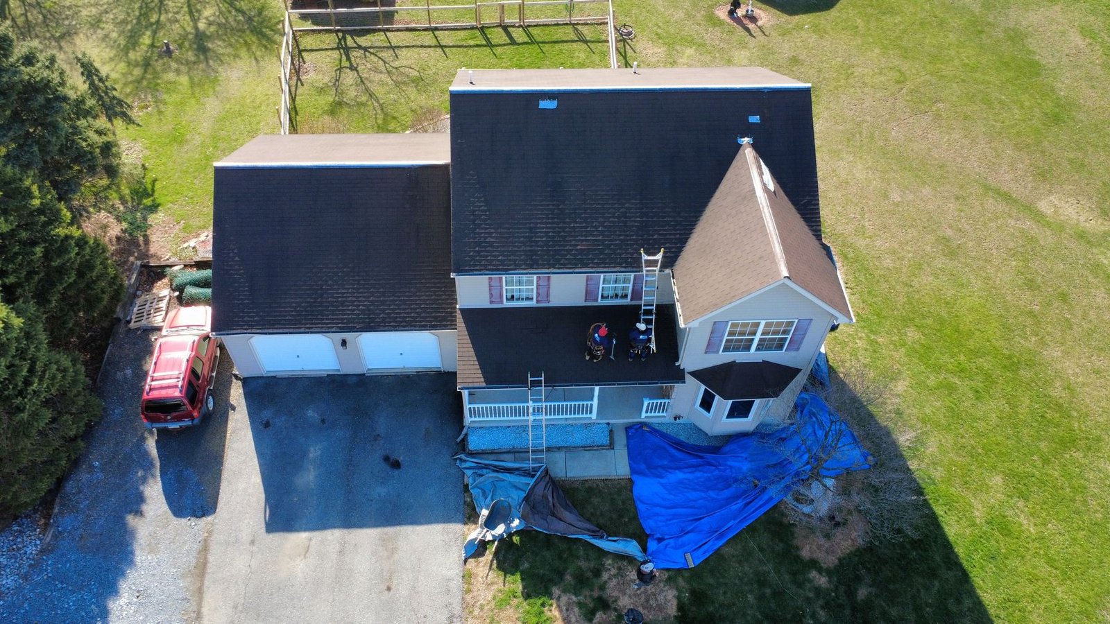 In-progress — crew tearing off old shingles on 2-story colonial, PA