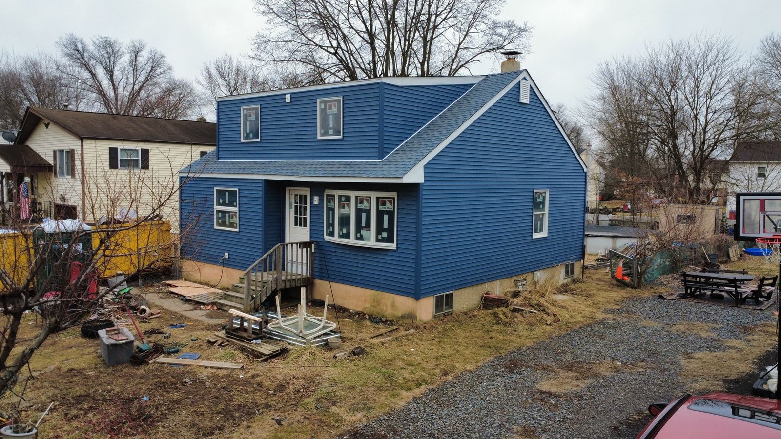 After — side of renovated cape with new blue siding and charcoal shingles — Shelby Roofing Services NJ