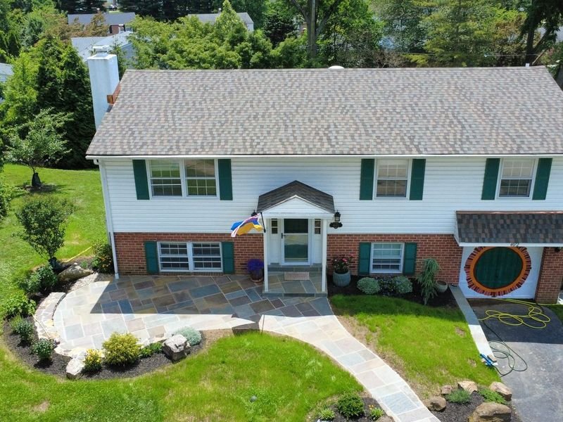 Split-level brick home in Lafayette Hill with a new roof and copper flashing — Shelby Roofing Services