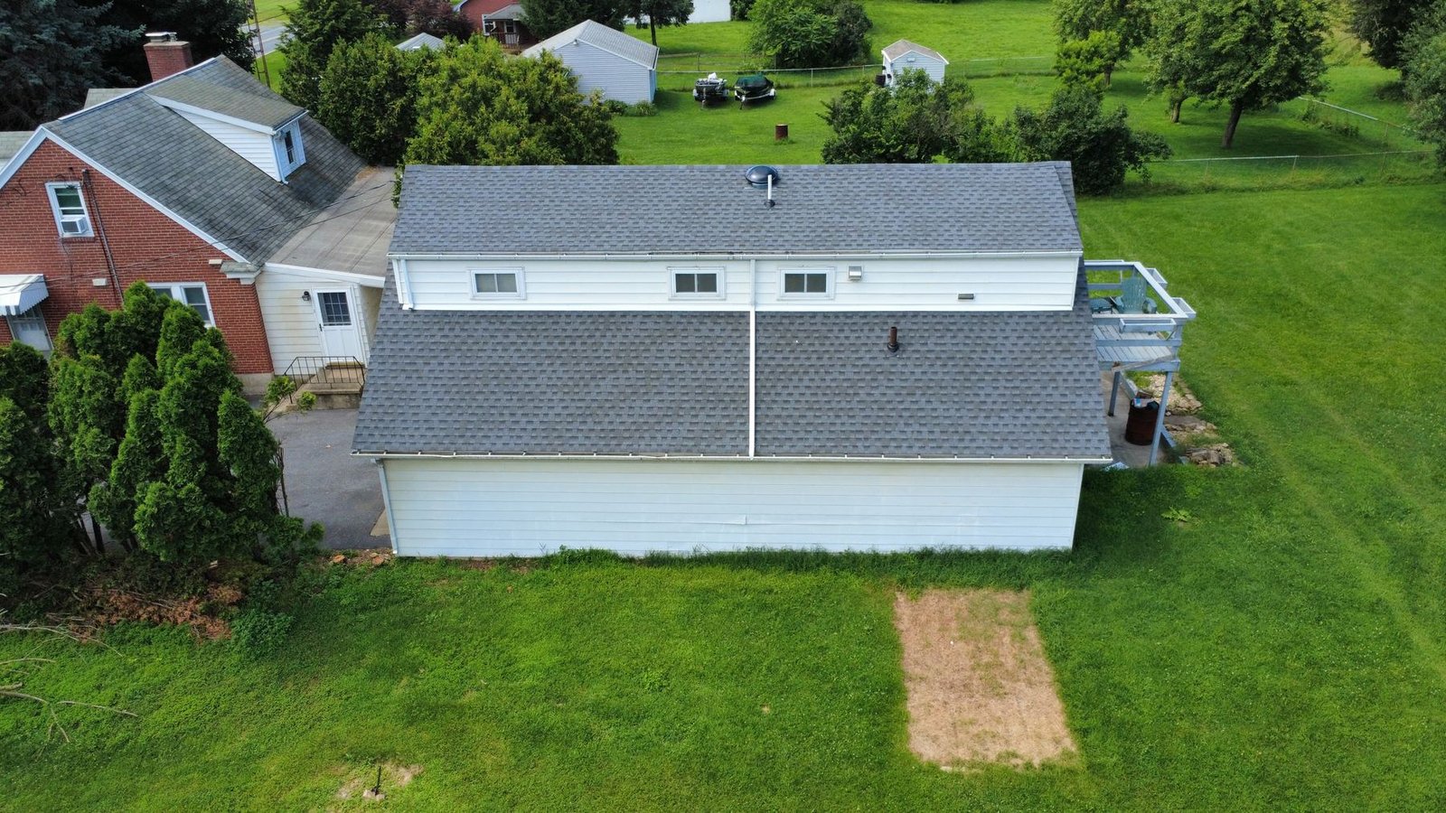 After — aerial of white ranch with new gray shingle roof — Shelby Roofing Services PA