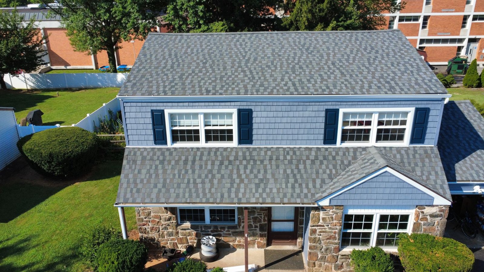 After — aerial view of completed stone colonial — Shelby Roofing Services PA
