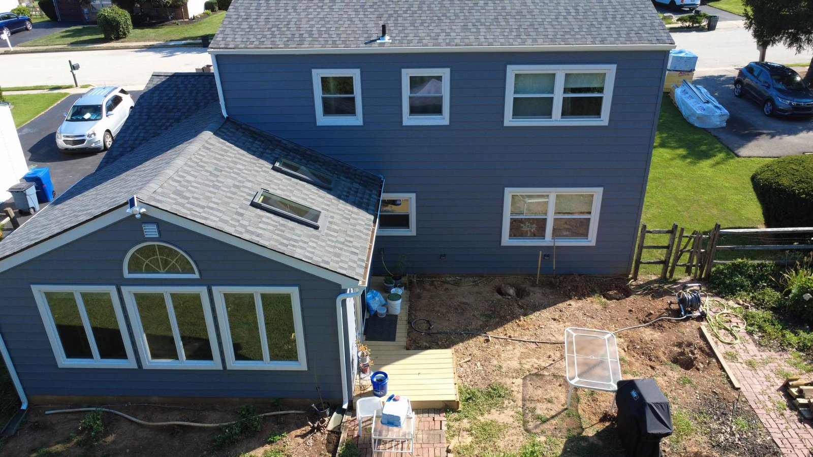 After — rear aerial of completed stone colonial — Shelby Roofing Services PA