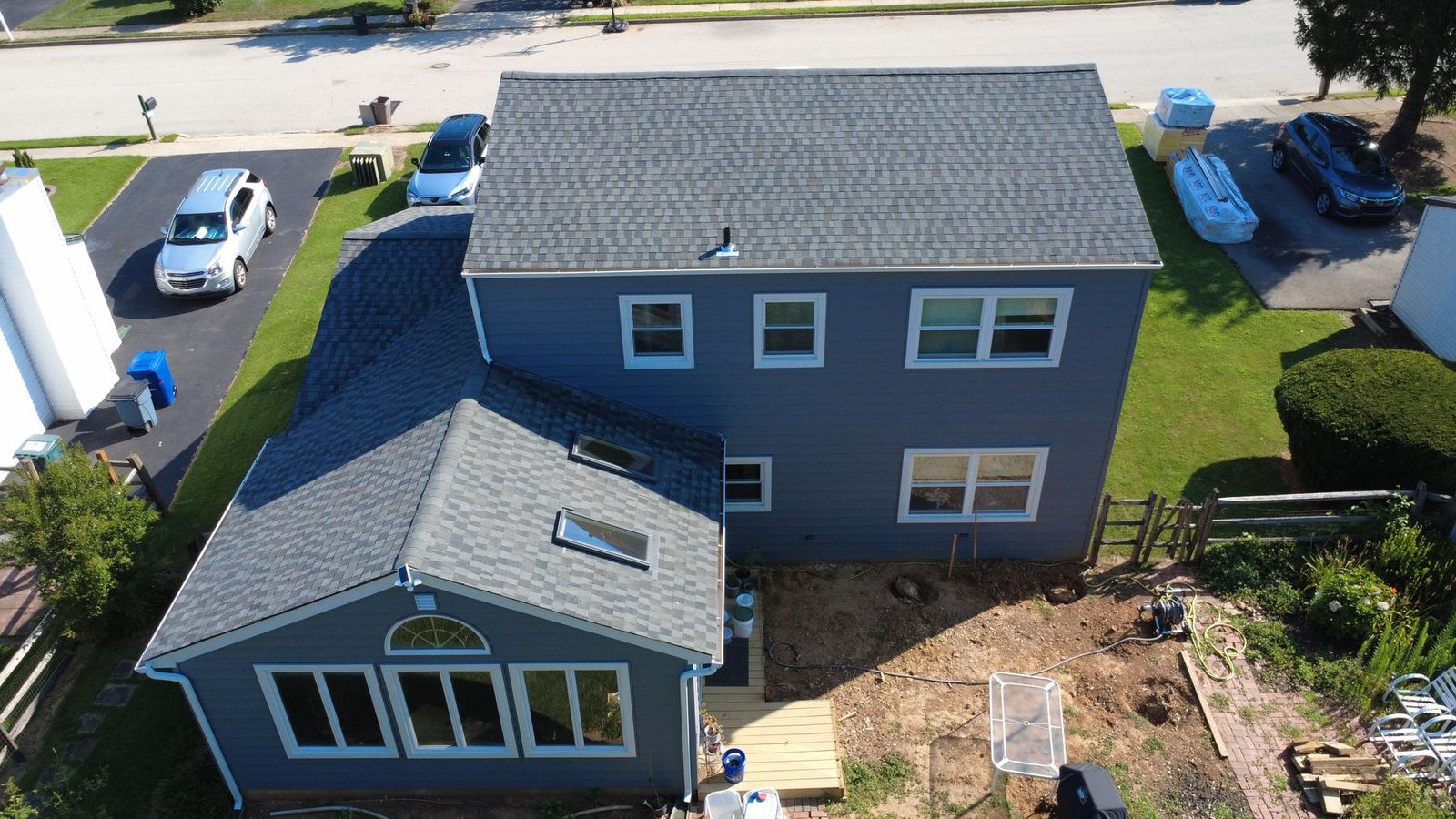 After — wide aerial of completed stone colonial property — Shelby Roofing Services PA