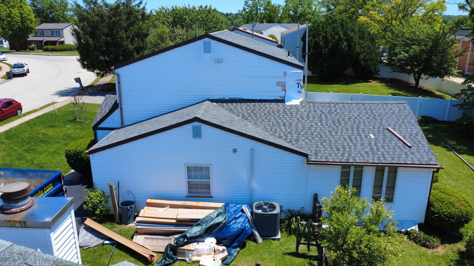 Before — aerial of stone colonial showing old dark roof, PA