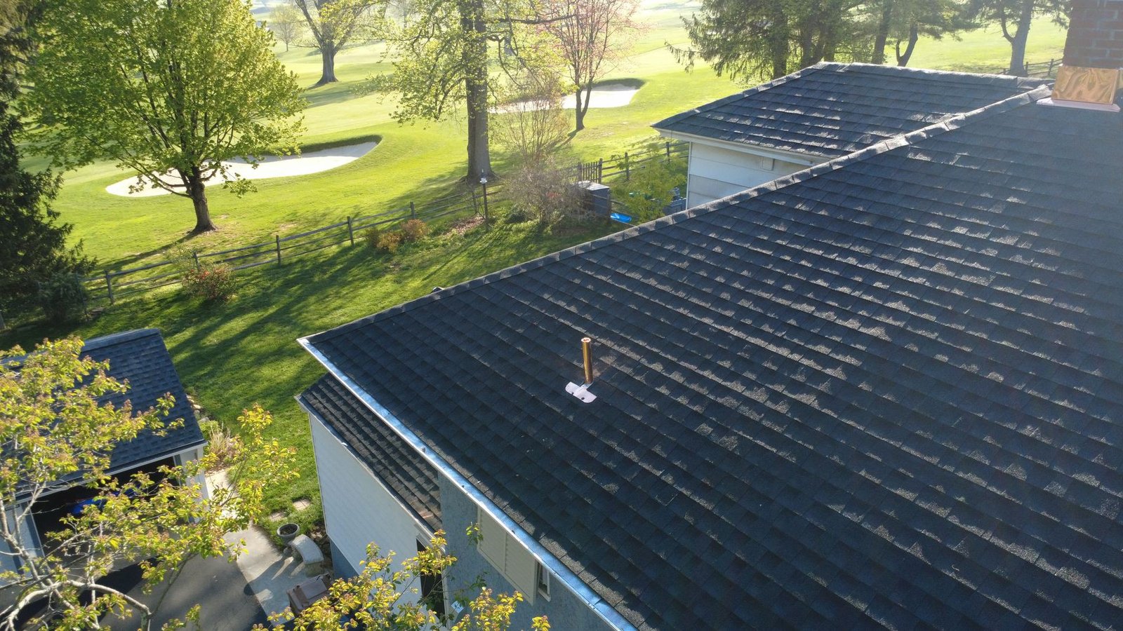 Aerial view of completed blue colonial with new premium dark shingles — Shelby Roofing Services PA