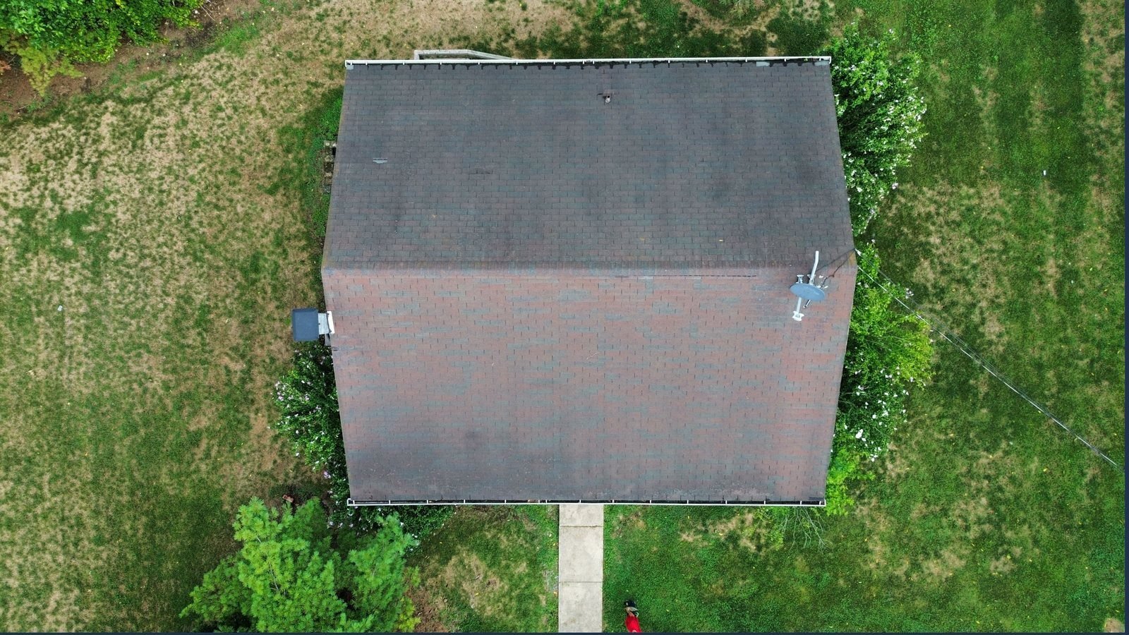 Before — top-down aerial of worn brown shingle roof, PA