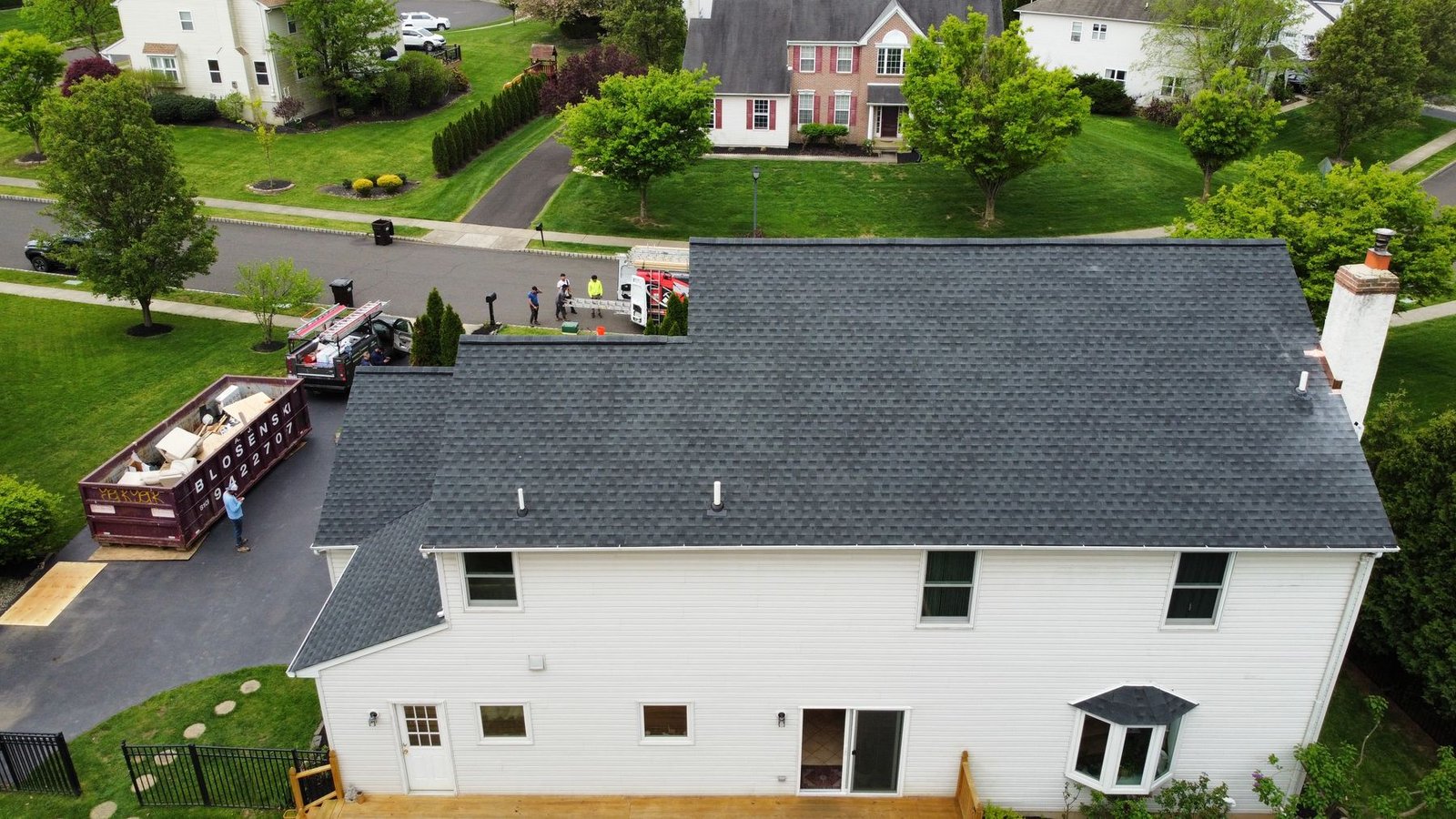After — rear aerial view with new shingles and crew completing the job — Shelby Roofing Services PA