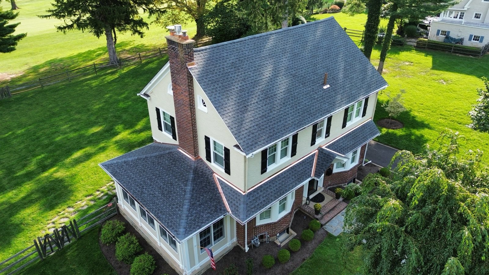 After — chimney side aerial with new shingles and new copper flashing — Shelby Roofing Services PA