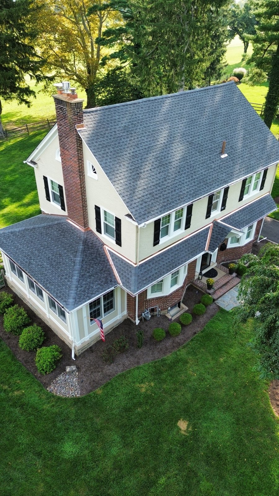 After — chimney side aerial with new shingles and copper flashing — Shelby Roofing Services PA