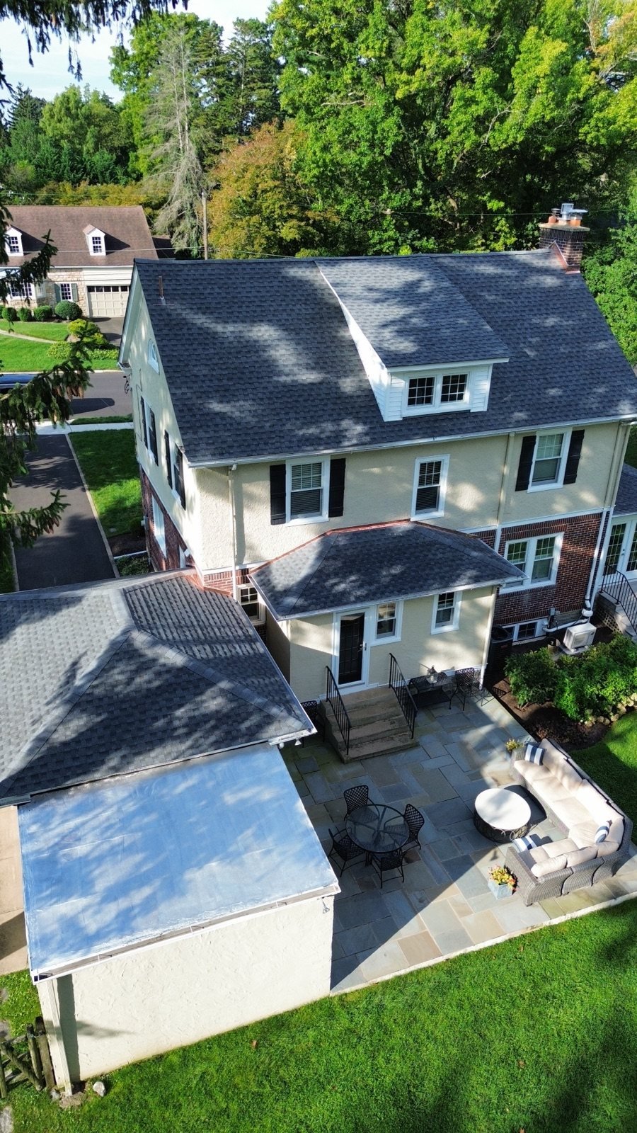 After — rear addition with new flat roof surface and new shingle roof — Shelby Roofing Services PA