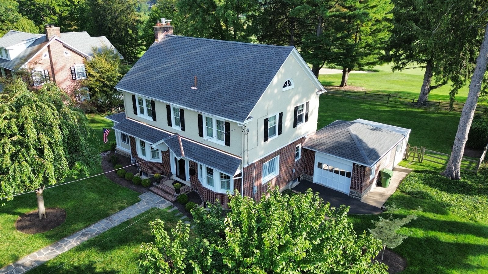 After — front corner aerial with new shingles on main house and garage — Shelby Roofing Services PA