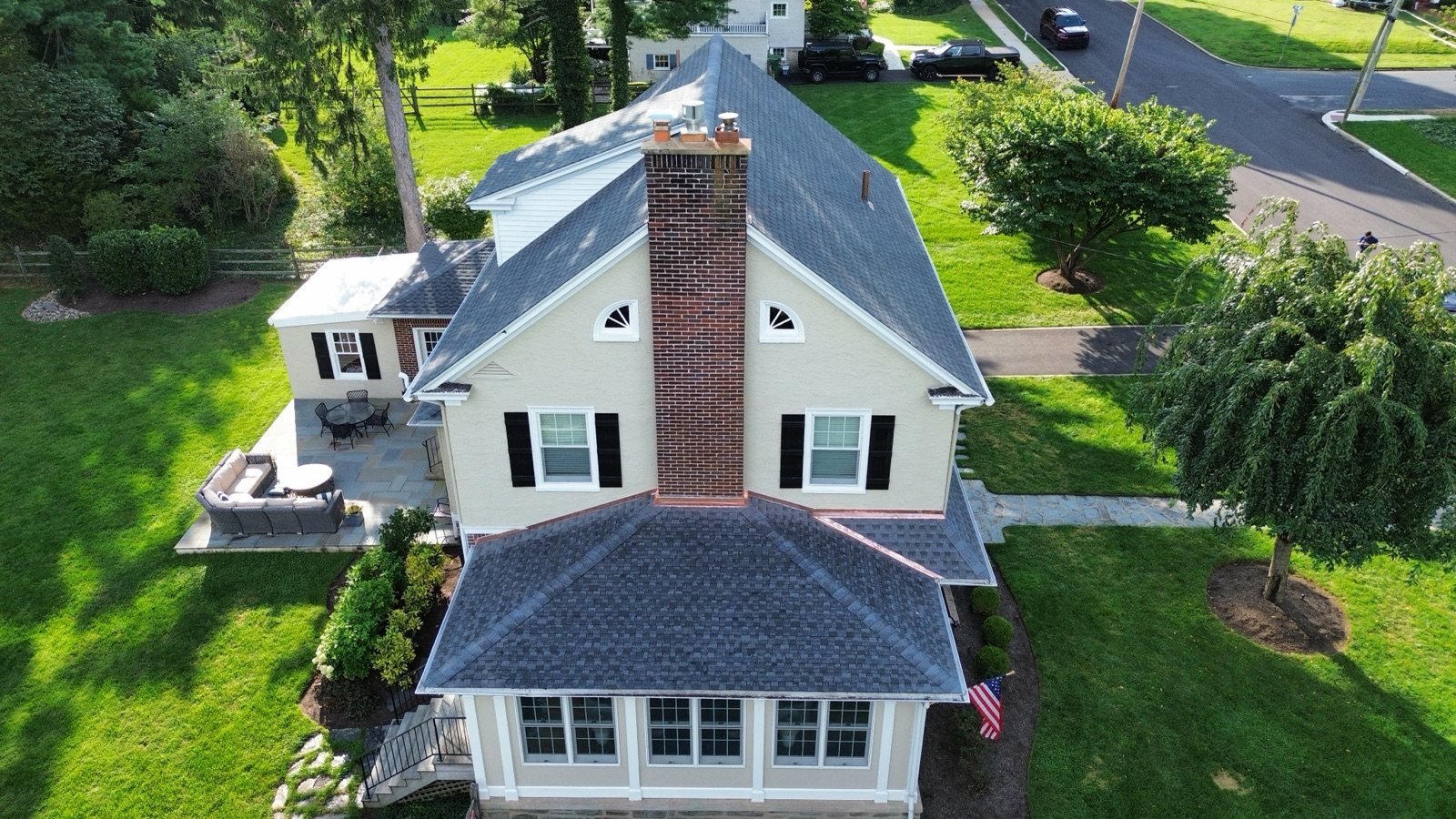 After — sunroom hip roof with new shingles and copper chimney flashing — Shelby Roofing Services PA