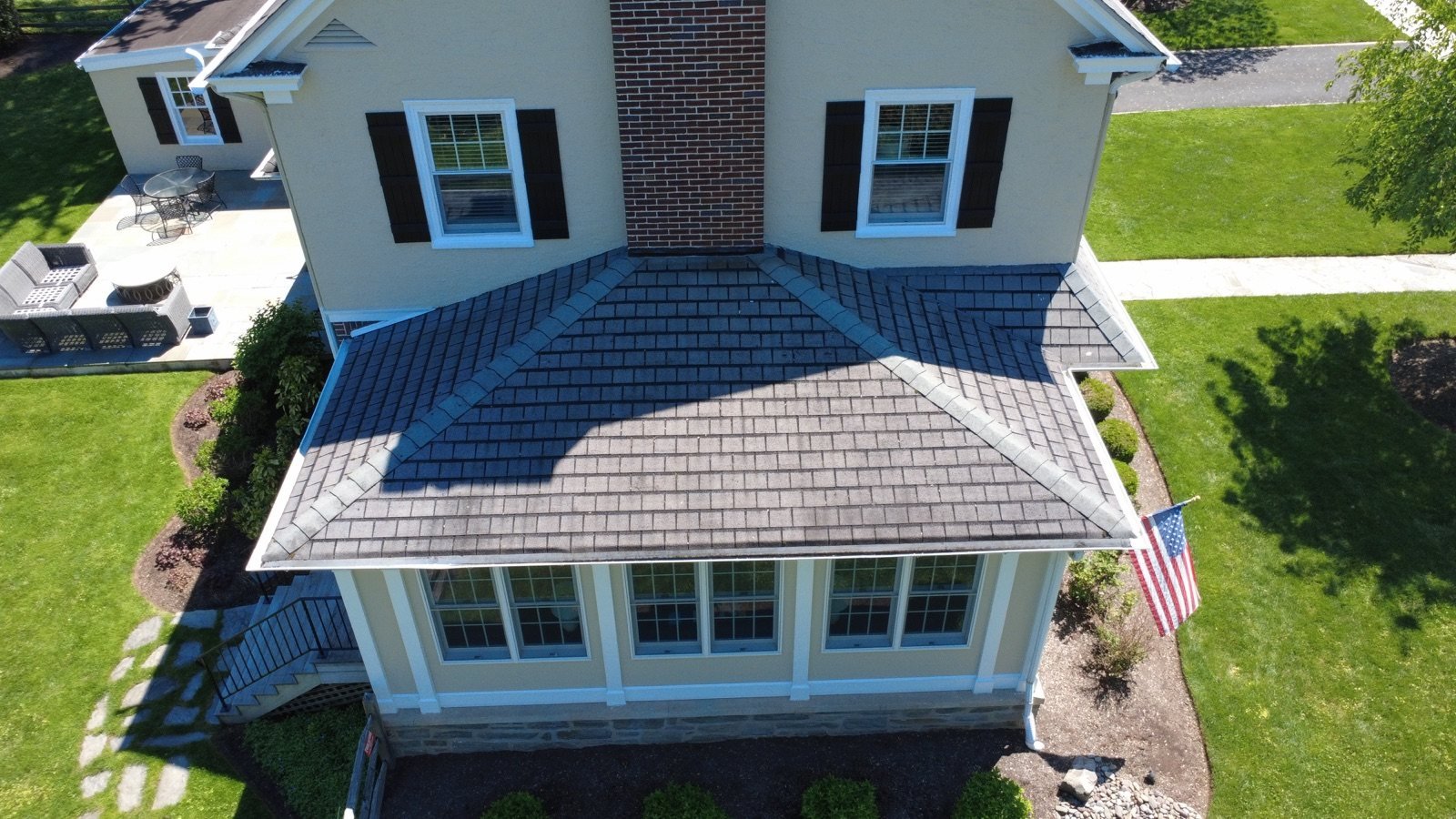 Before — sunroom hip roof and chimney with aging, stained shingles, PA