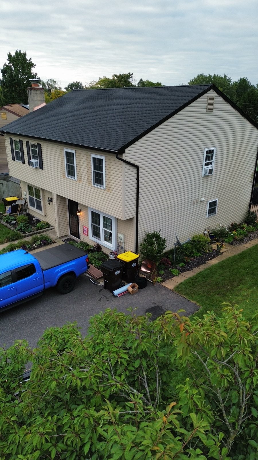 After — front corner view with new black shingles, fascia and gutters — Shelby Roofing Services PA