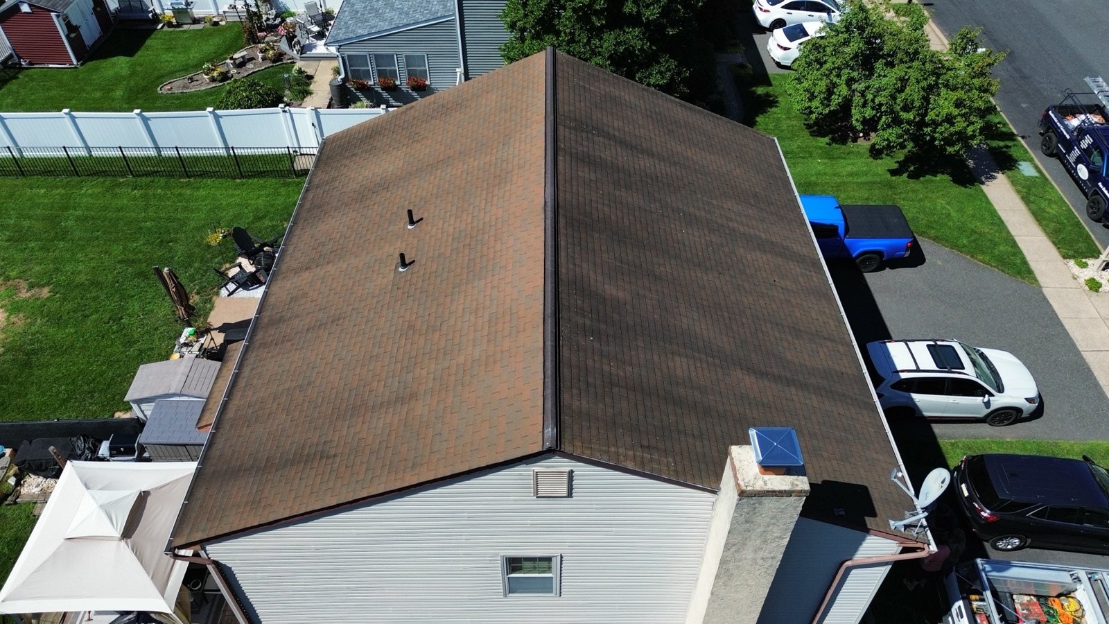 Before — chimney side aerial of worn brown shingle roof, PA