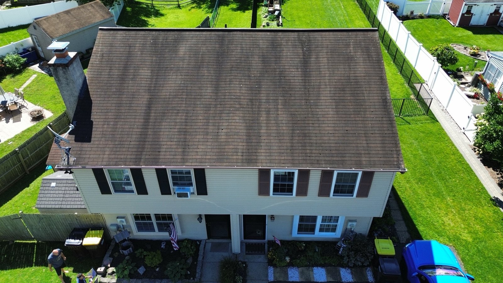Before — front aerial of two-story home with worn, faded brown shingle roof, PA