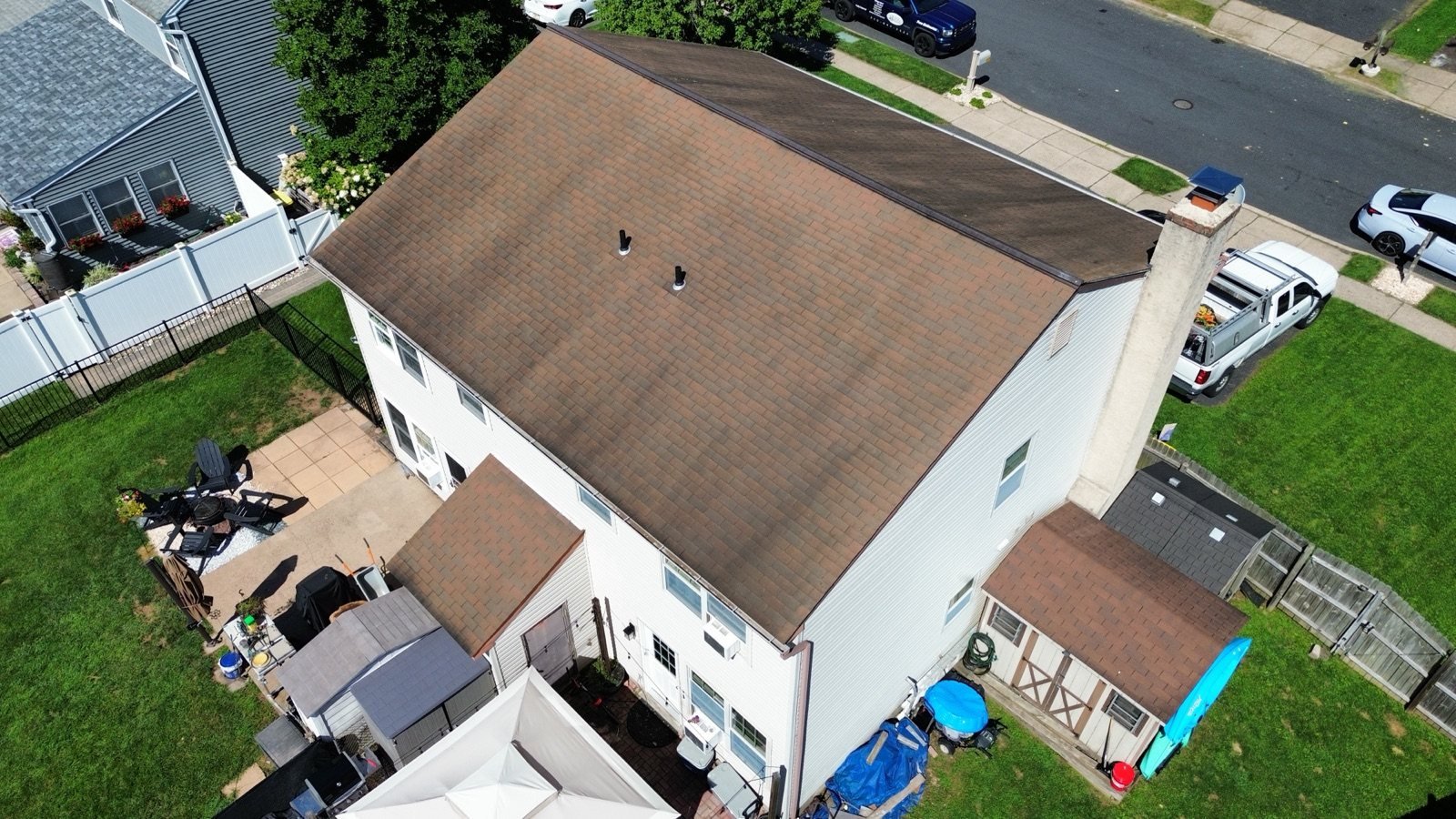 Before — rear corner aerial of worn brown shingle roof, PA