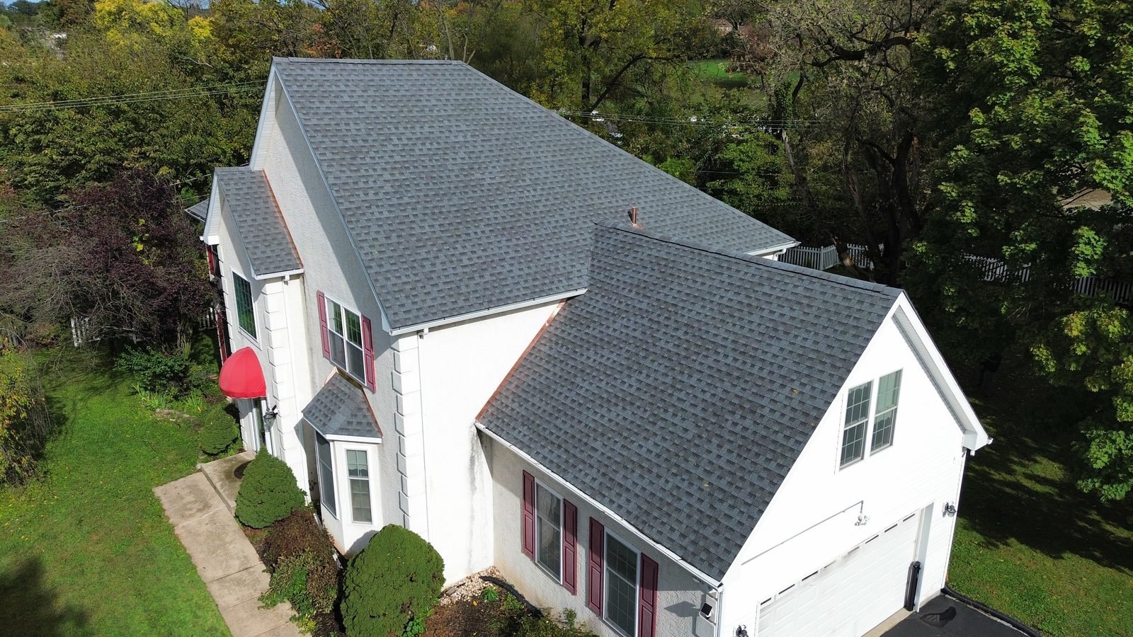 After — garage side aerial of the completed shingle roof with copper counter flashing, Plymouth Meeting PA — Shelby Roofing Services