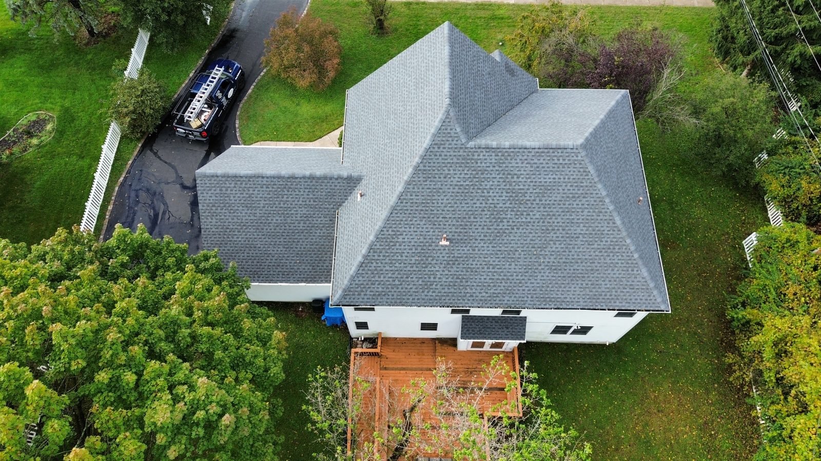 After — rear aerial of the new gray shingle roof over the main house and garage, Plymouth Meeting PA — Shelby Roofing Services
