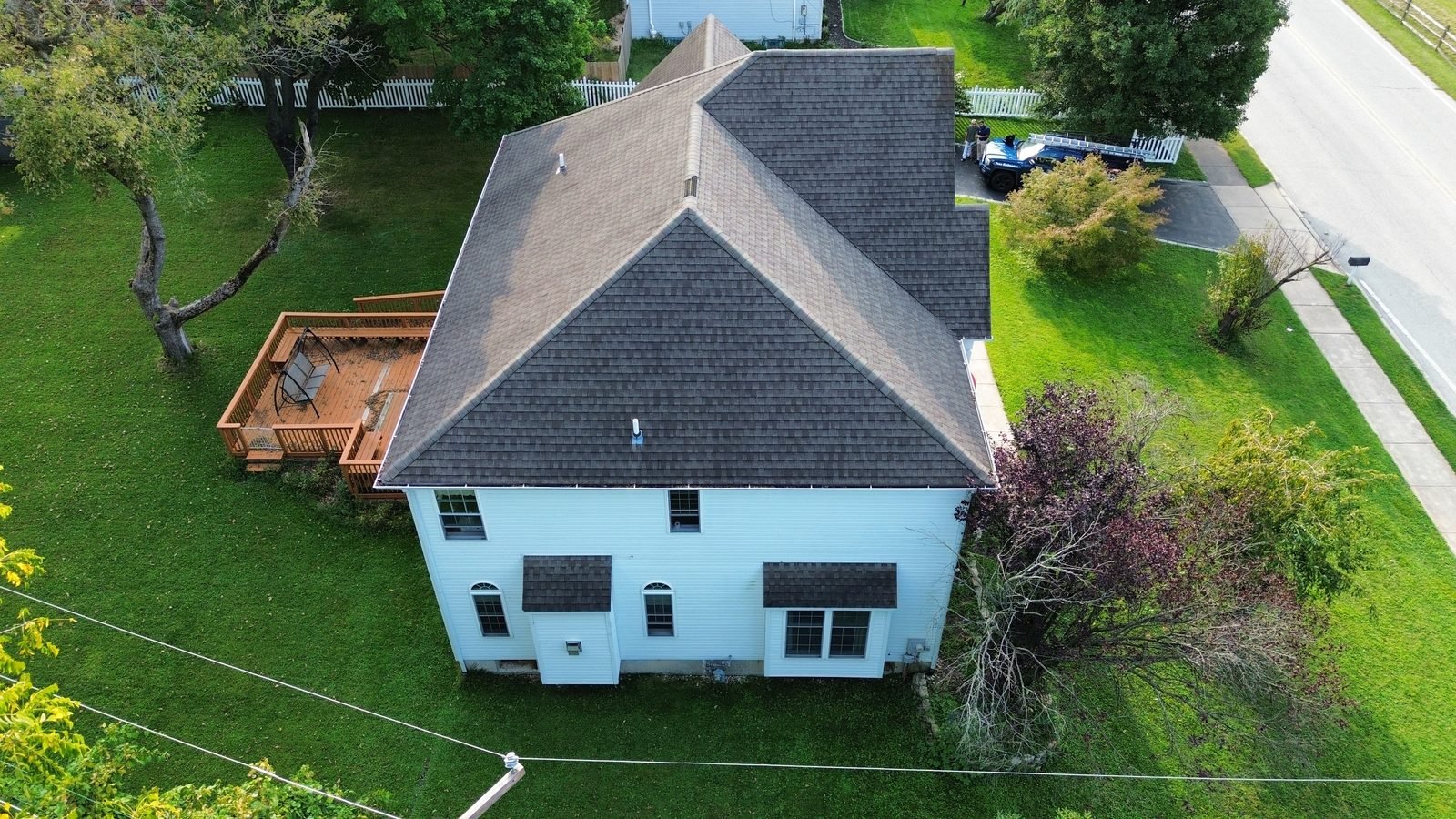 Before — rear corner aerial with deck showing the original brown shingle roof, Plymouth Meeting PA
