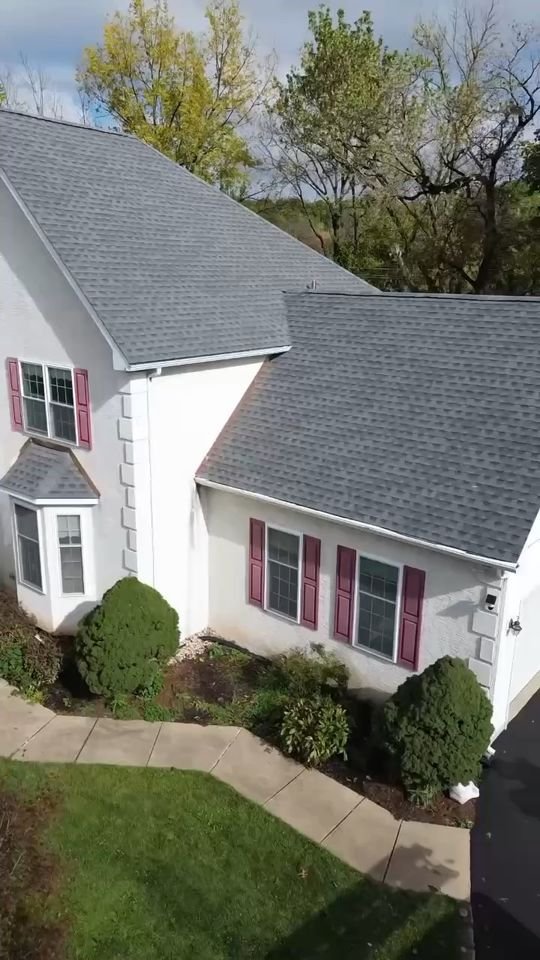 Drone view of a just-completed shingle roof with copper flashing on a stucco colonial in Plymouth Meeting, PA, Shelby Roofing Services video