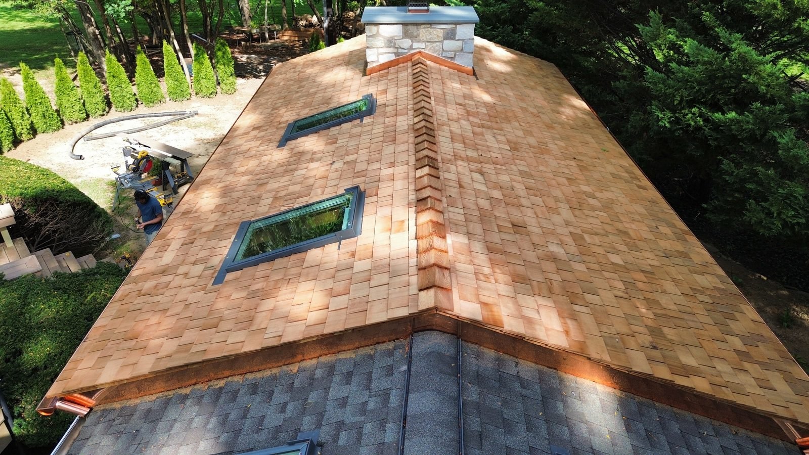 Aerial — new cedar shake porch roof with cedar ridge, skylights and stone chimney, Bryn Athyn PA — Shelby Roofing Services